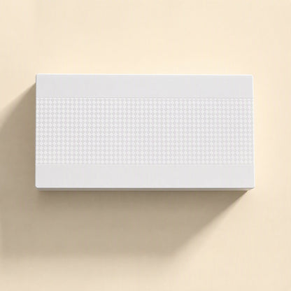 Deskport Desktop Network Switch – top view of white switch lid with a raised diamond-pattern band on a cream background