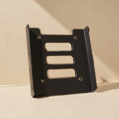 Diskcradle – Front view of the black metal bracket standing upright, showing three slotted cutouts and four mounting holes
