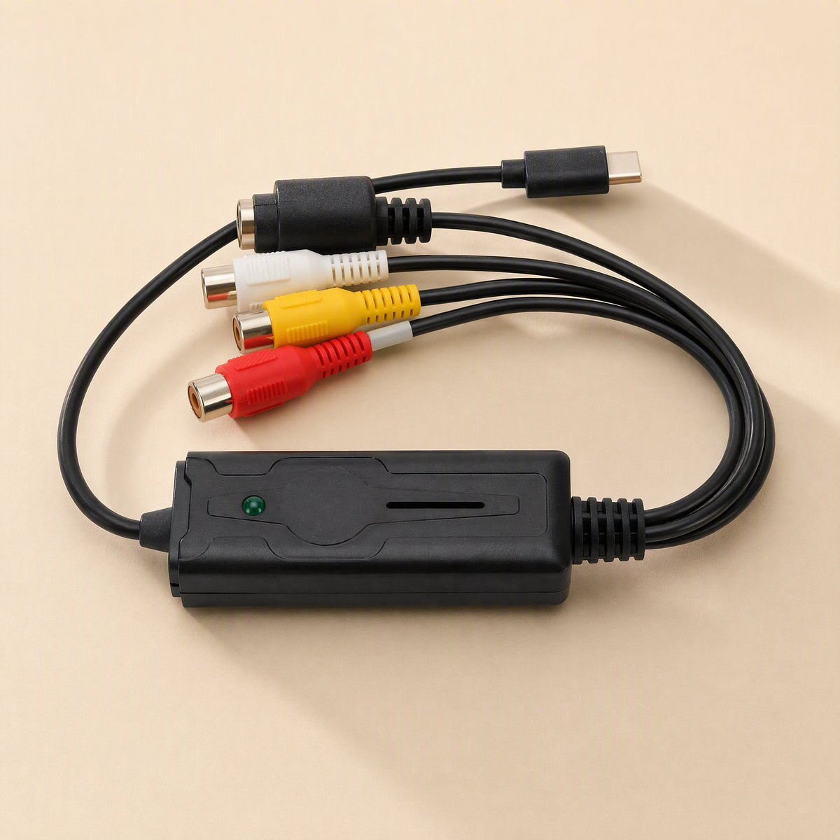 Streamport USB-C Video Capture Card with S-Video and red, white, yellow RCA jacks, top view on beige