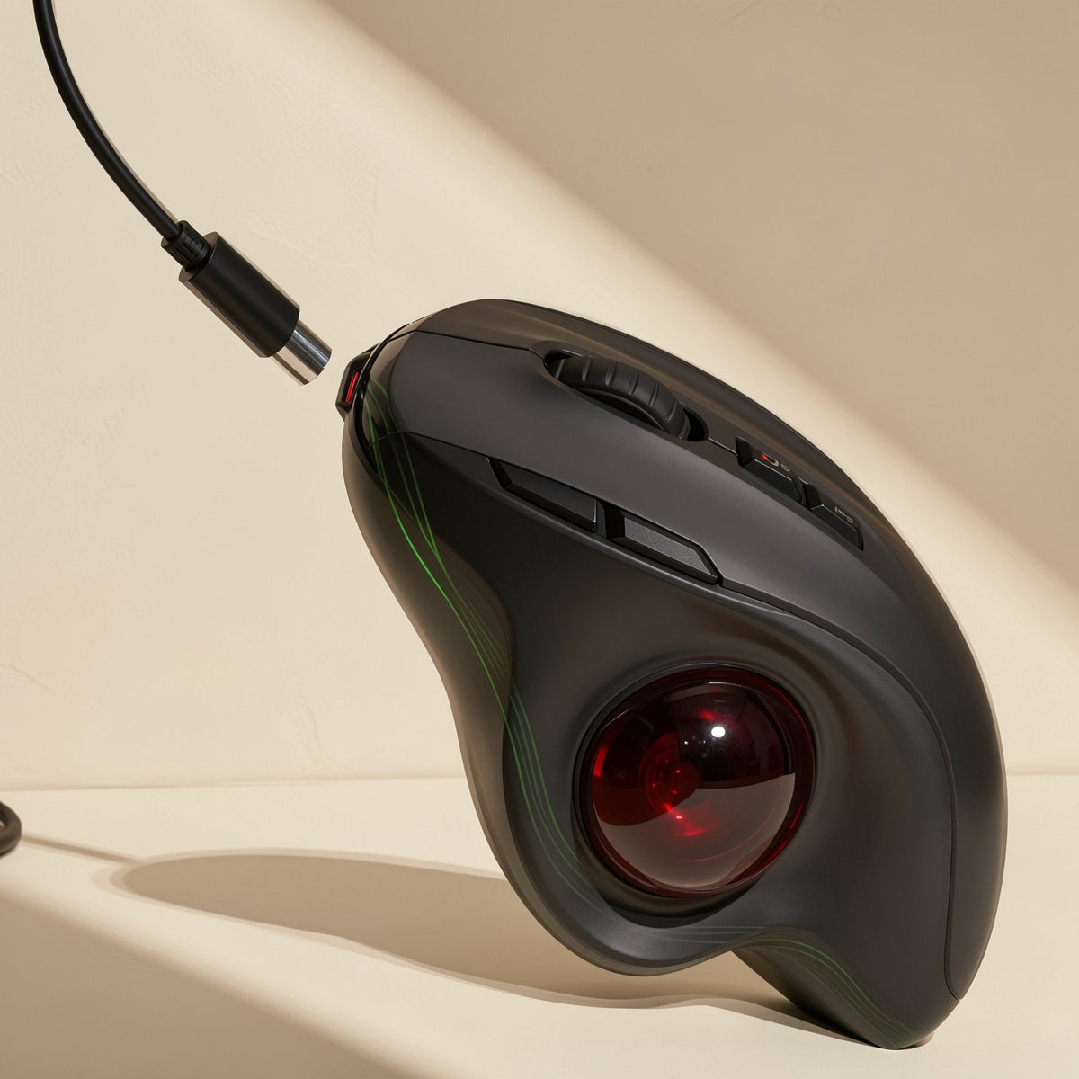 Palmorbit – Tilted trackball mouse with a USB-C cable plugged in and a red ball with faint green accent lines