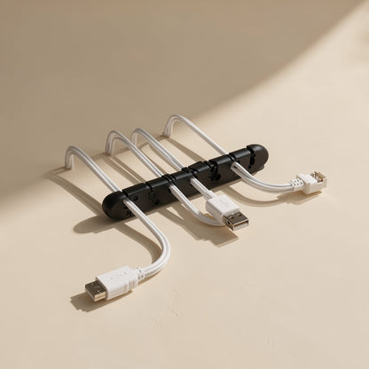 Silinest – Black cable organizer lying flat with four white USB and Ethernet-style cables looping out from its slots