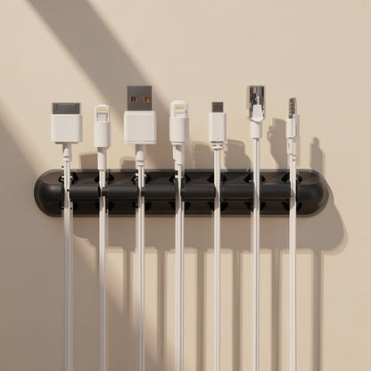 Silinest – Wall-mounted black organizer holding seven white cables, including 30-pin, Lightning, USB-A and audio plugs