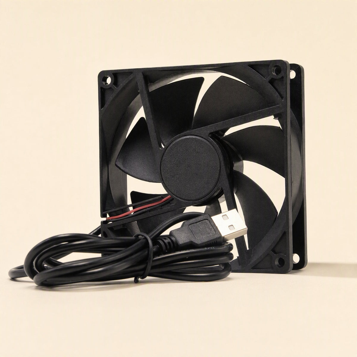 Coolbyte – Side-angle view of the black fan showing frame thickness, center hub and the USB connector resting in front