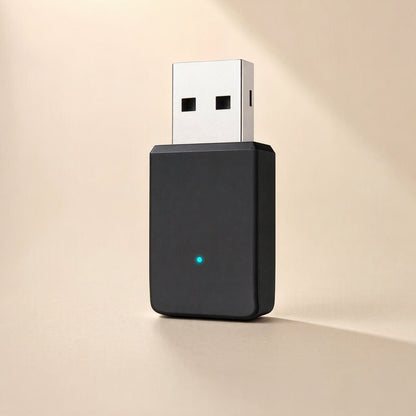 Bandbridge – Black USB adapter with silver connector and small blue LED, angled view in soft side lighting