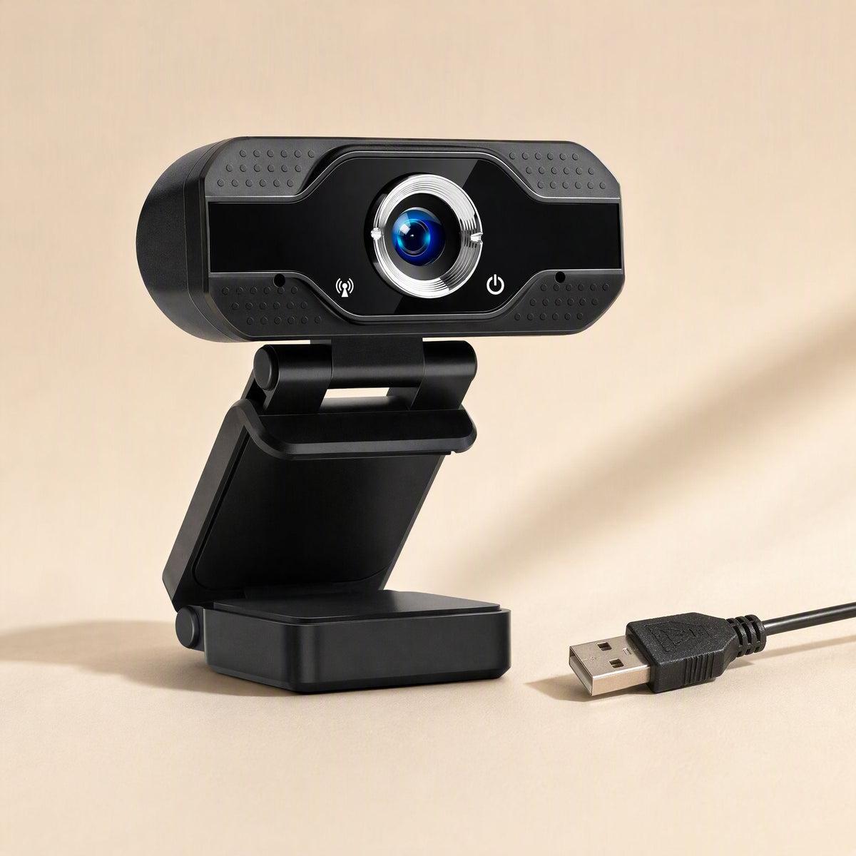 Camclear USB Webcam in black with silver-ringed lens, folding clip stand and USB cable on a beige background