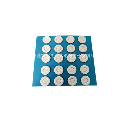 Puckdot – Blue backing sheet with twenty white round glide discs, each with a ring detail, in four columns and five rows