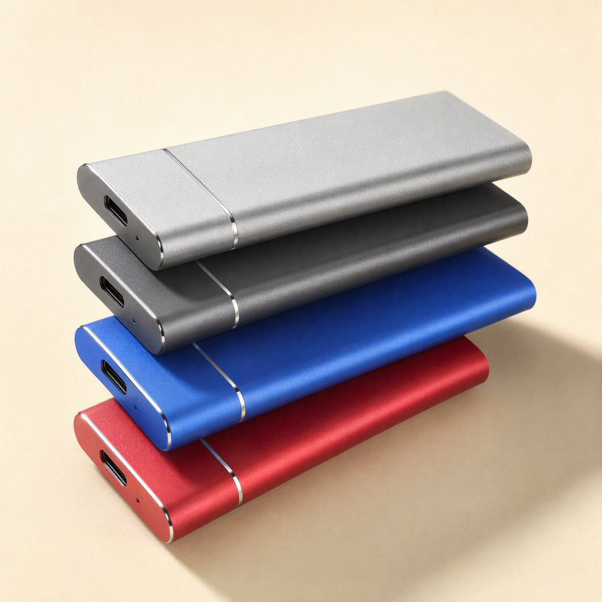 Solidrive Portable SSD in gray, dark gray, blue and red stacked at an angle, USB-C ports facing front
