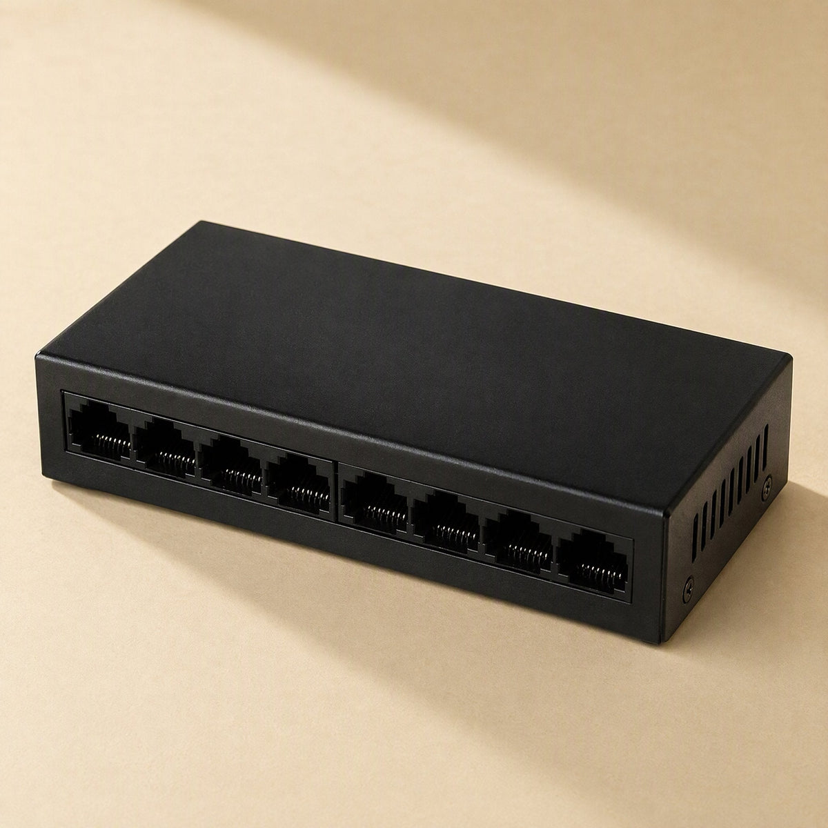 Gigaflow – Black eight-port metal switch seen from above at an angle, with side ventilation slots on a beige surface