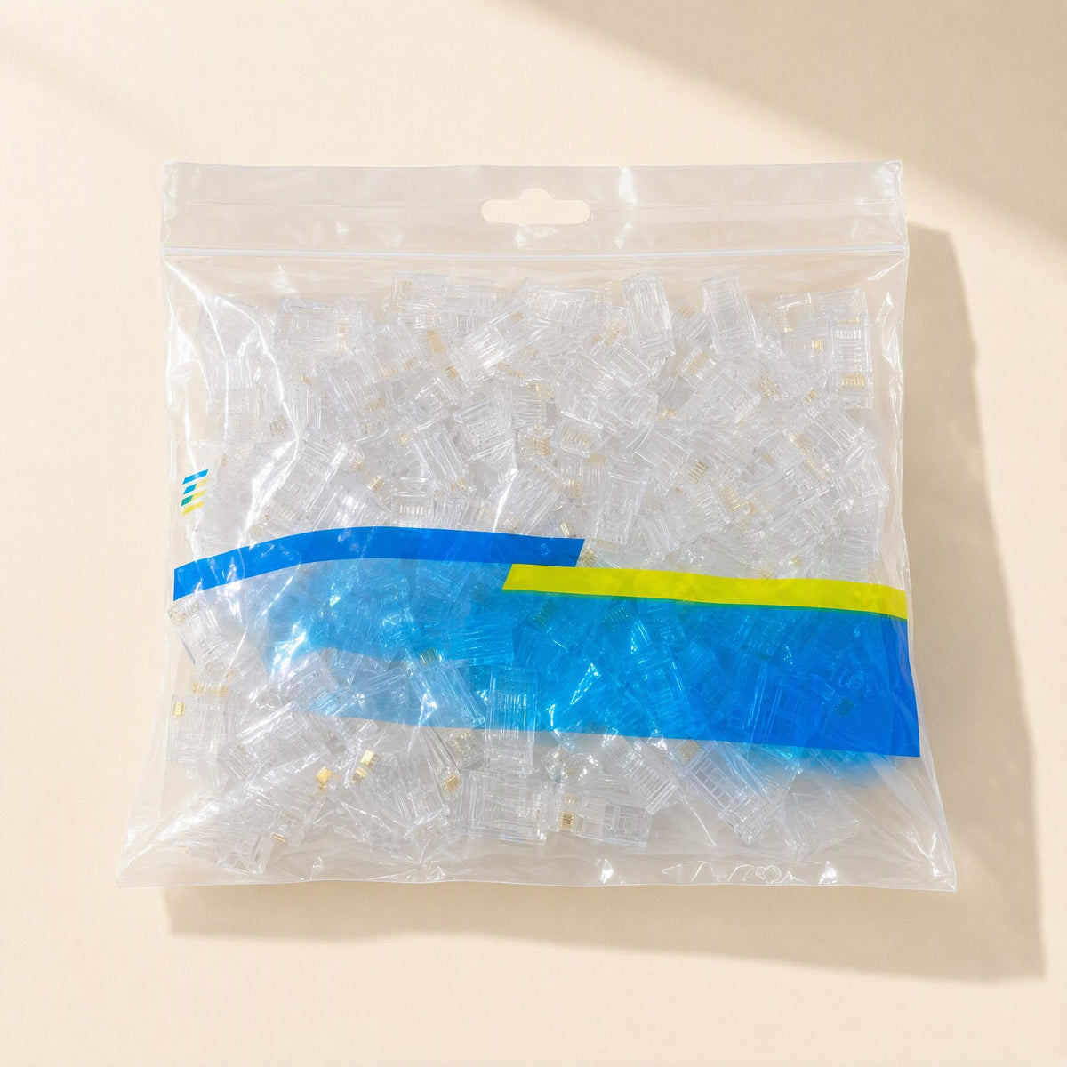 Snaplink – Clear zip-top bag filled with many transparent RJ45 connectors and a blue and yellow label