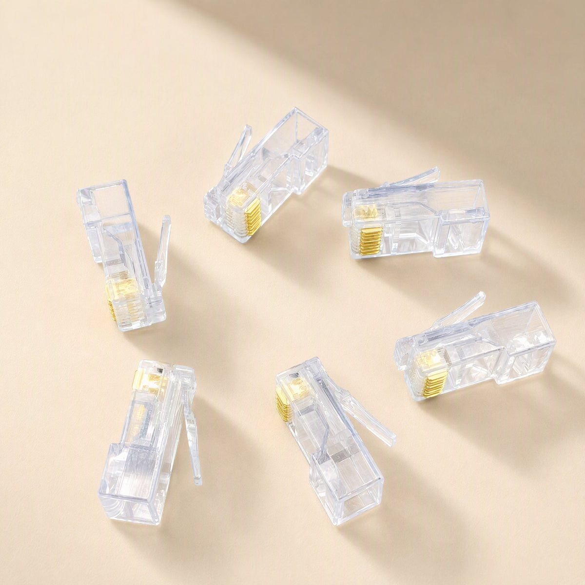 Snaplink – Six clear RJ45 connectors scattered at different angles, gold pins and release tabs visible