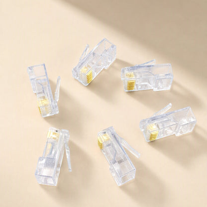 Snaplink – Six clear RJ45 connectors scattered at different angles, gold pins and release tabs visible