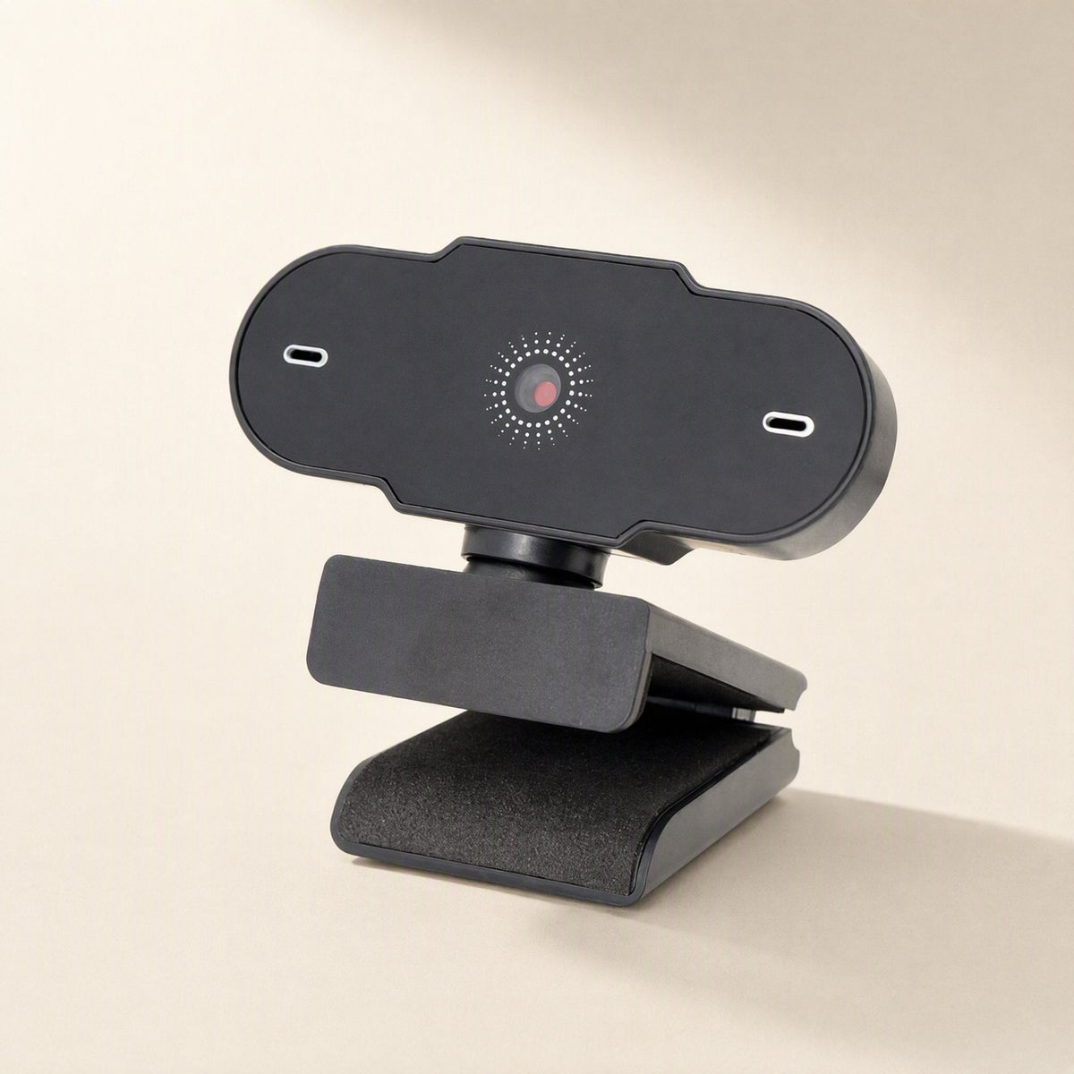 Weblens Computer USB Webcam angled three-quarter view on a cream background, showing the black body and lens