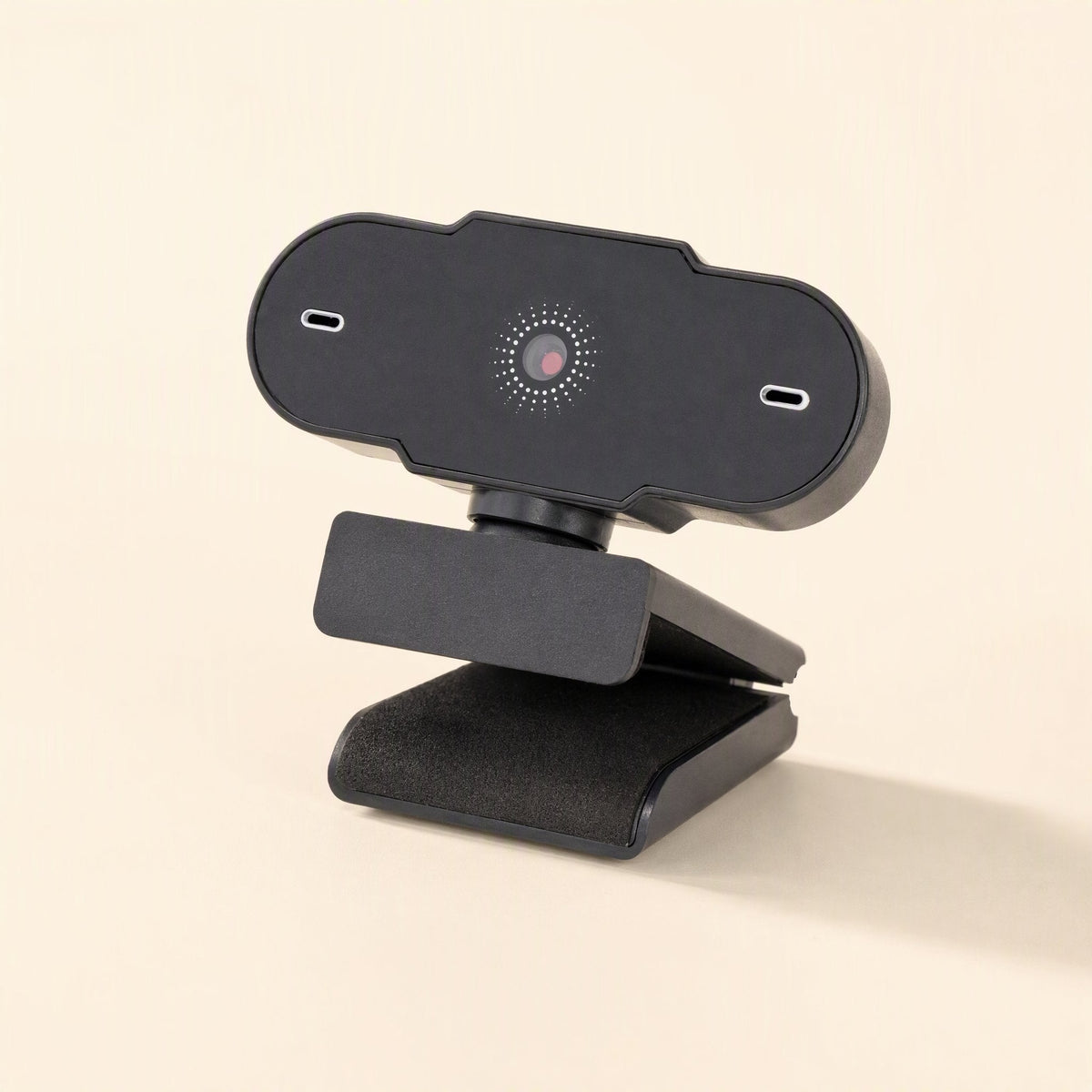 Weblens – Webcam seen from a slightly different three-quarter angle, with the padded clip resting on a flat surface