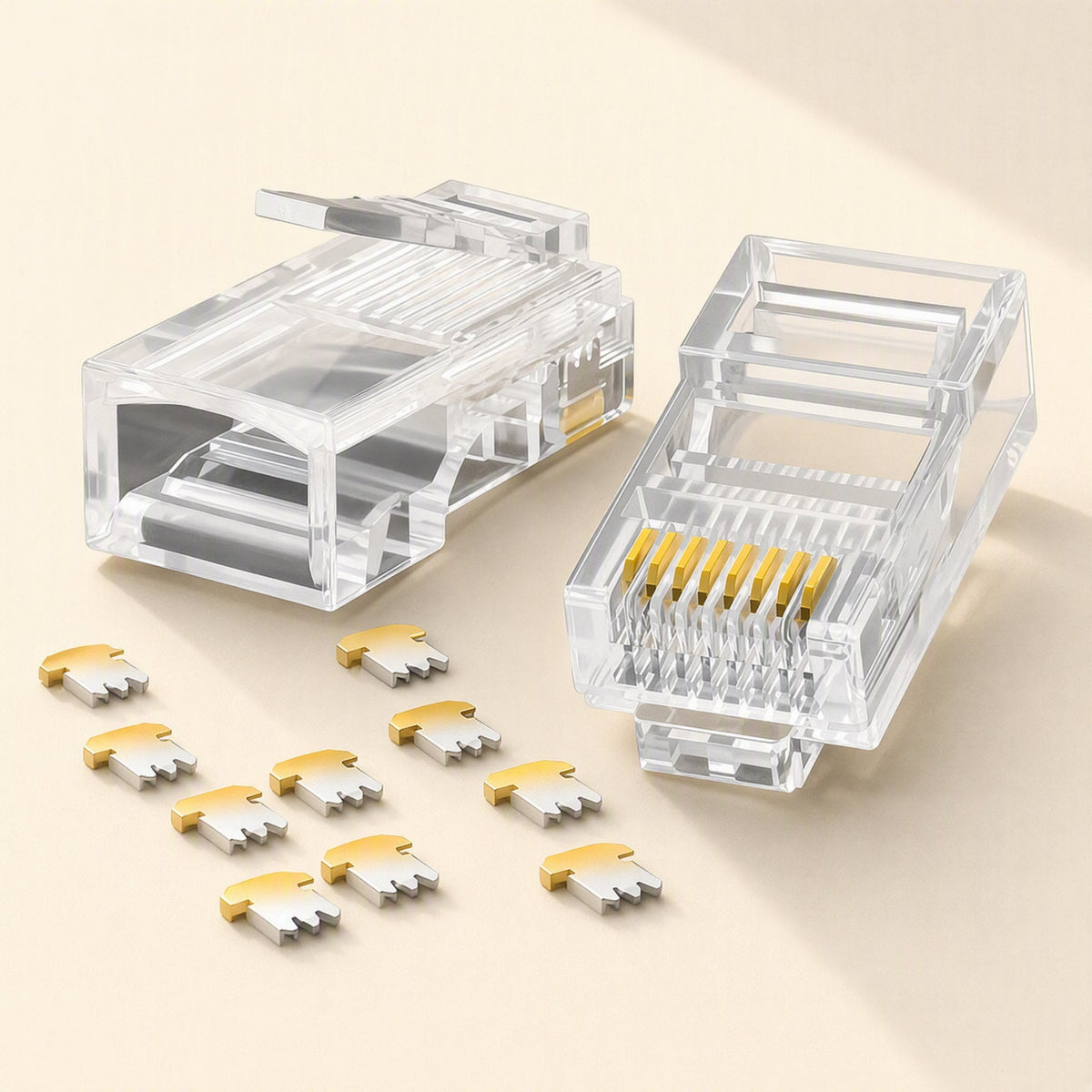 Linksnap – Two clear RJ45 connector housings with nine loose gold-and-silver contact inserts scattered below