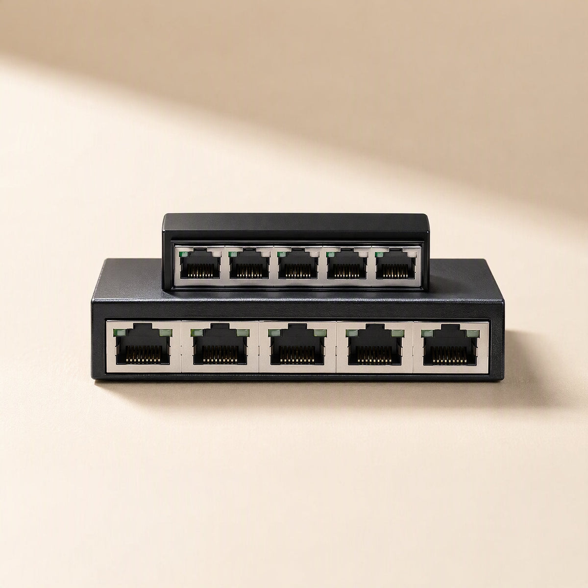Fiveflow – Front view of two black switches showing their rows of Ethernet ports, the smaller one on top