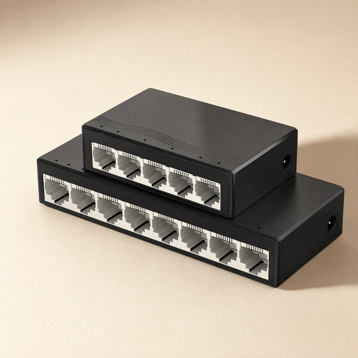 Fiveflow – Five-port switch angled above a larger eight-port black switch, ports facing forward on a tan surface