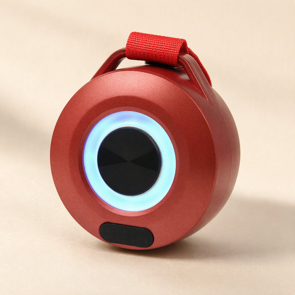 Minibeat LED Bluetooth Mini Speaker in red with a glowing blue light ring and red fabric strap, three-quarter view