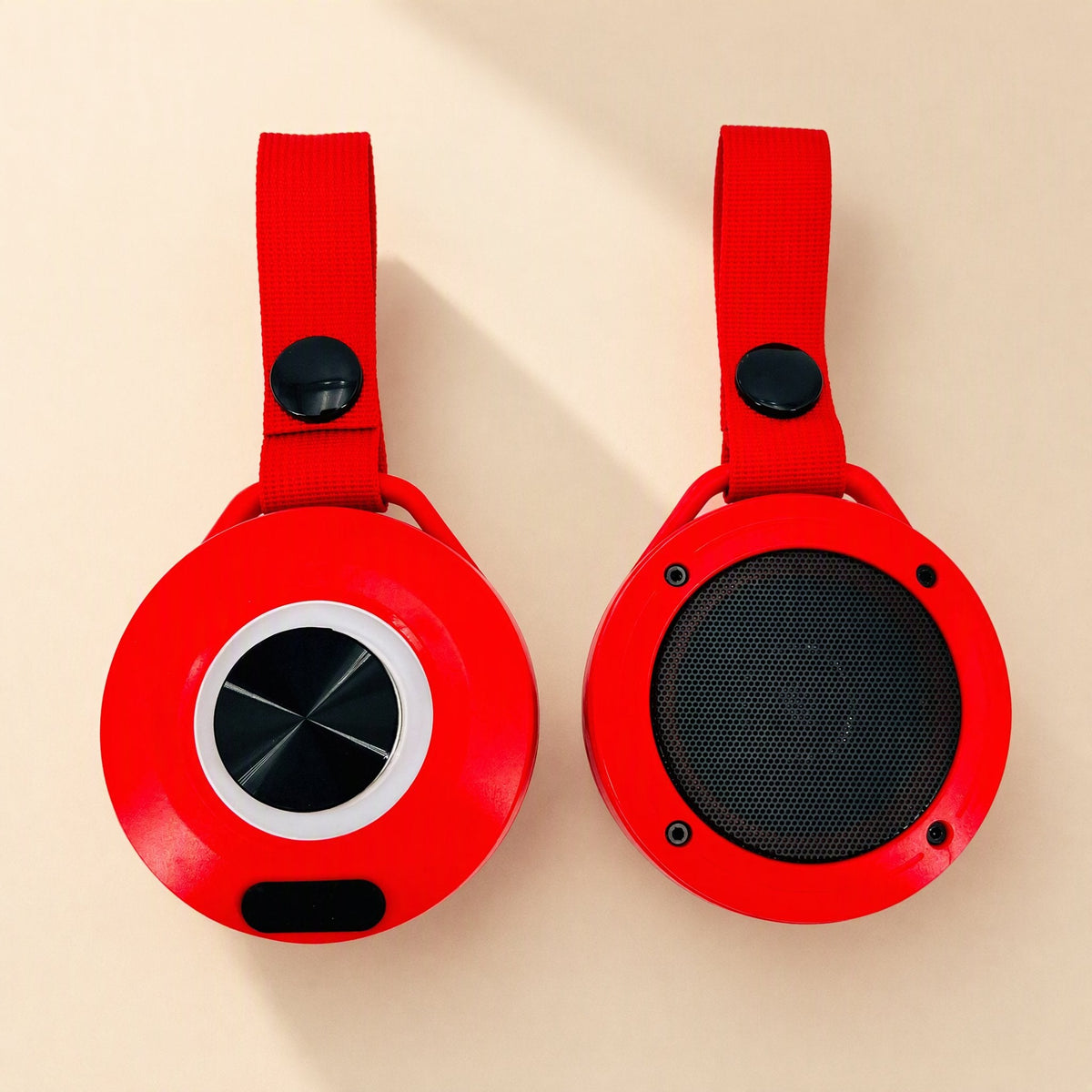 Minibeat – Red speakers shown front and back, with a white light ring on the front and a round black mesh grille on the back
