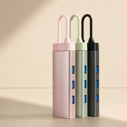 Dockcraft USB-C Multiport Docking Station in pink, sage green and black, standing with three blue USB ports