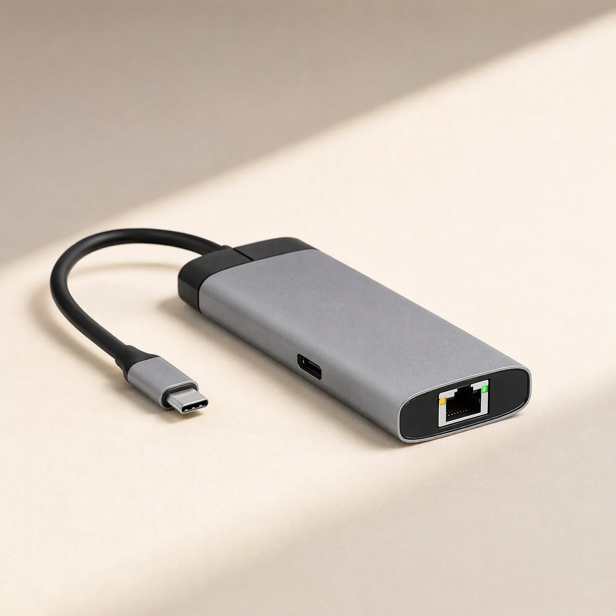 Dockcraft – Top-angle view of the gray docking station with Ethernet port and USB-C port on a cream surface