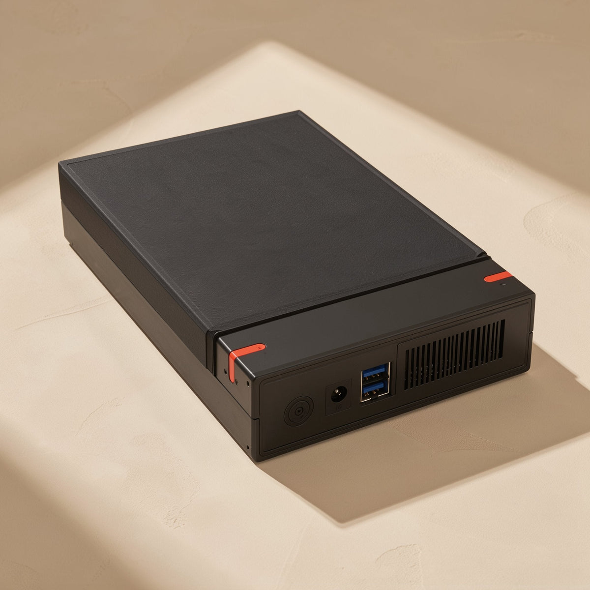 Drivestow – Box lying flat, showing a power button, DC jack, two blue USB ports and a side vent on the end panel