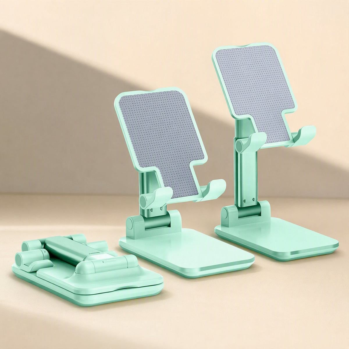 Pocketprop Foldable Mobile Phone Stand in mint green, shown folded flat and raised at two heights