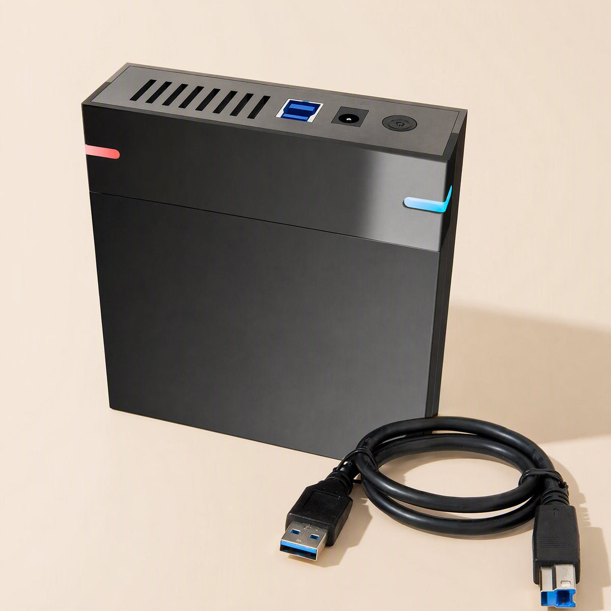Baybox – Enclosure upright beside a black USB 3.0 cable with Type-A and Type-B connectors, ports on top