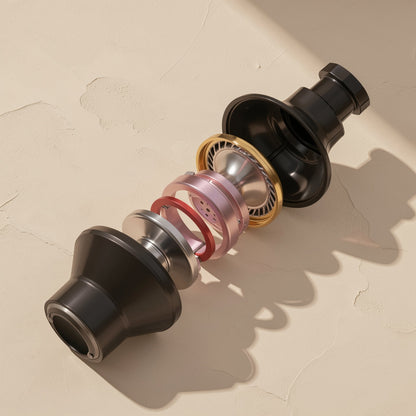 Cordtone – Exploded view of an earbud driver with black housing, gold ring, pink and red parts, and silver cone