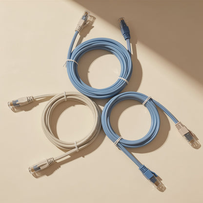 Signalweave Cat6 Gigabit Network Cable coiled in blue and beige loops on a cream surface in angled sunlight