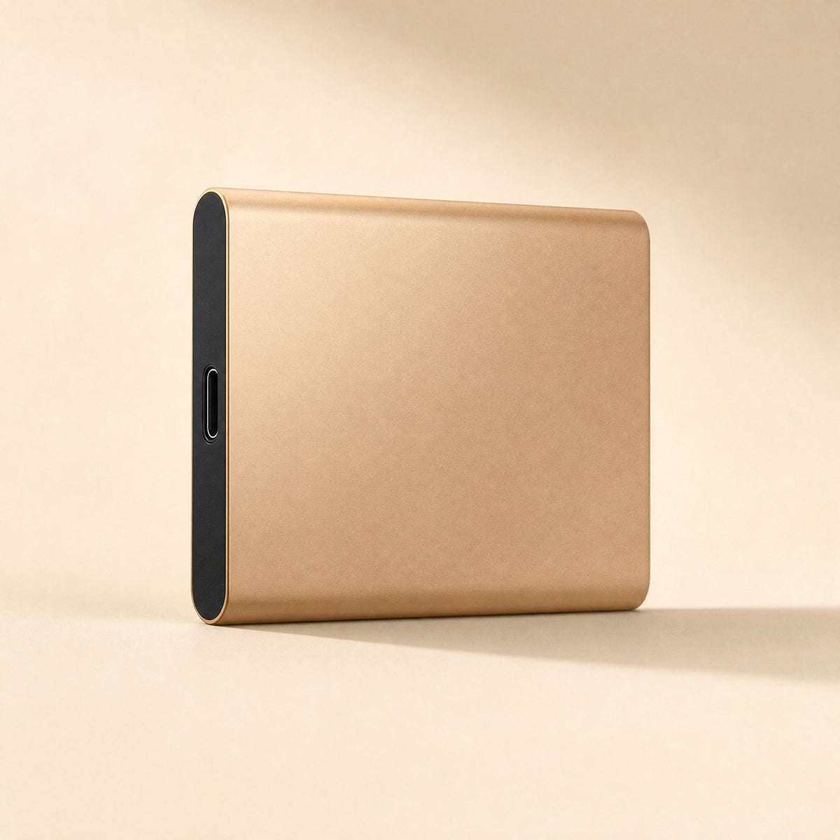Slimstore – Gold slim portable drive standing on its edge, with the black end and USB-C port facing forward