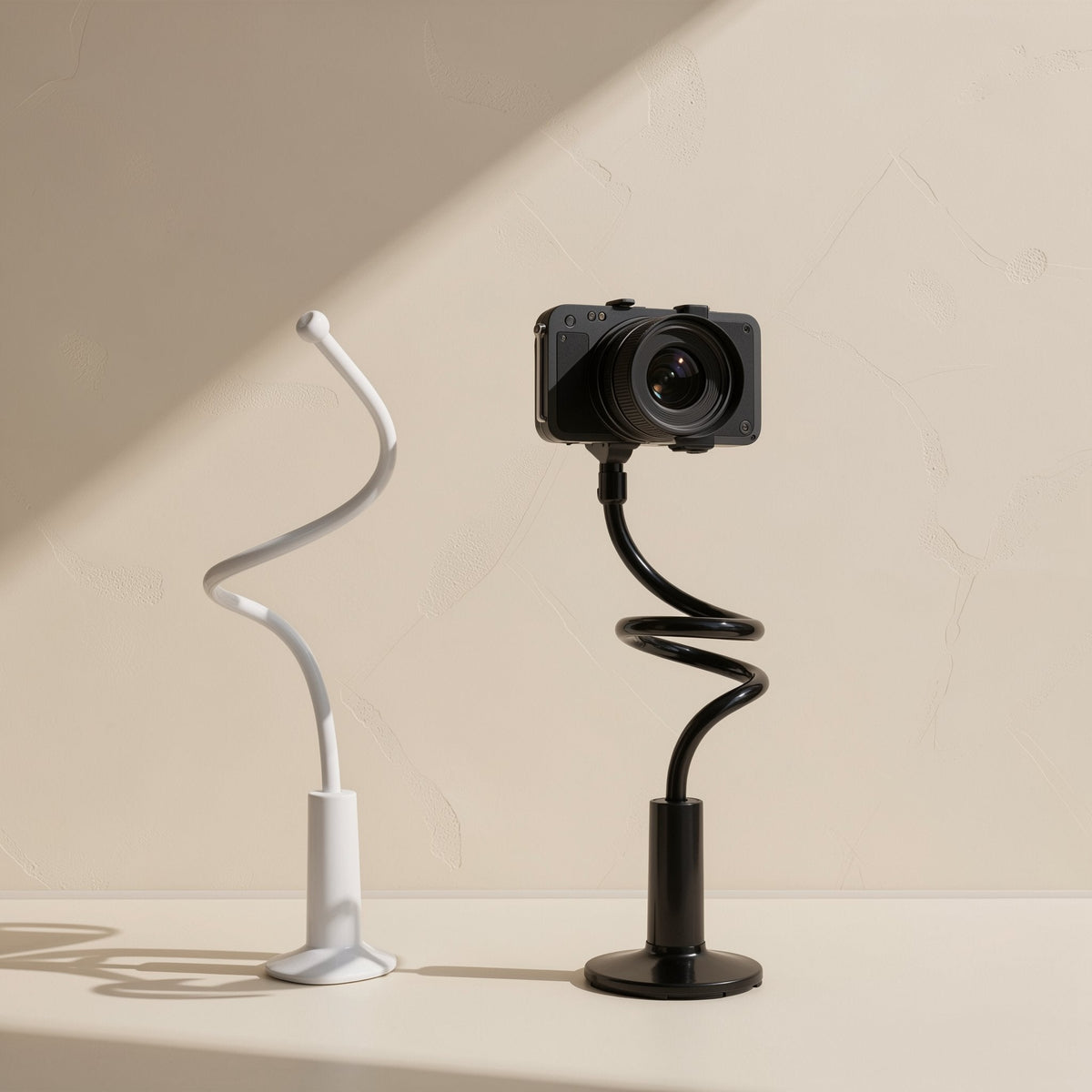 Tiltprop Adjustable Mobile Phone Stand in white and black, each with a coiled flexible arm on a round base