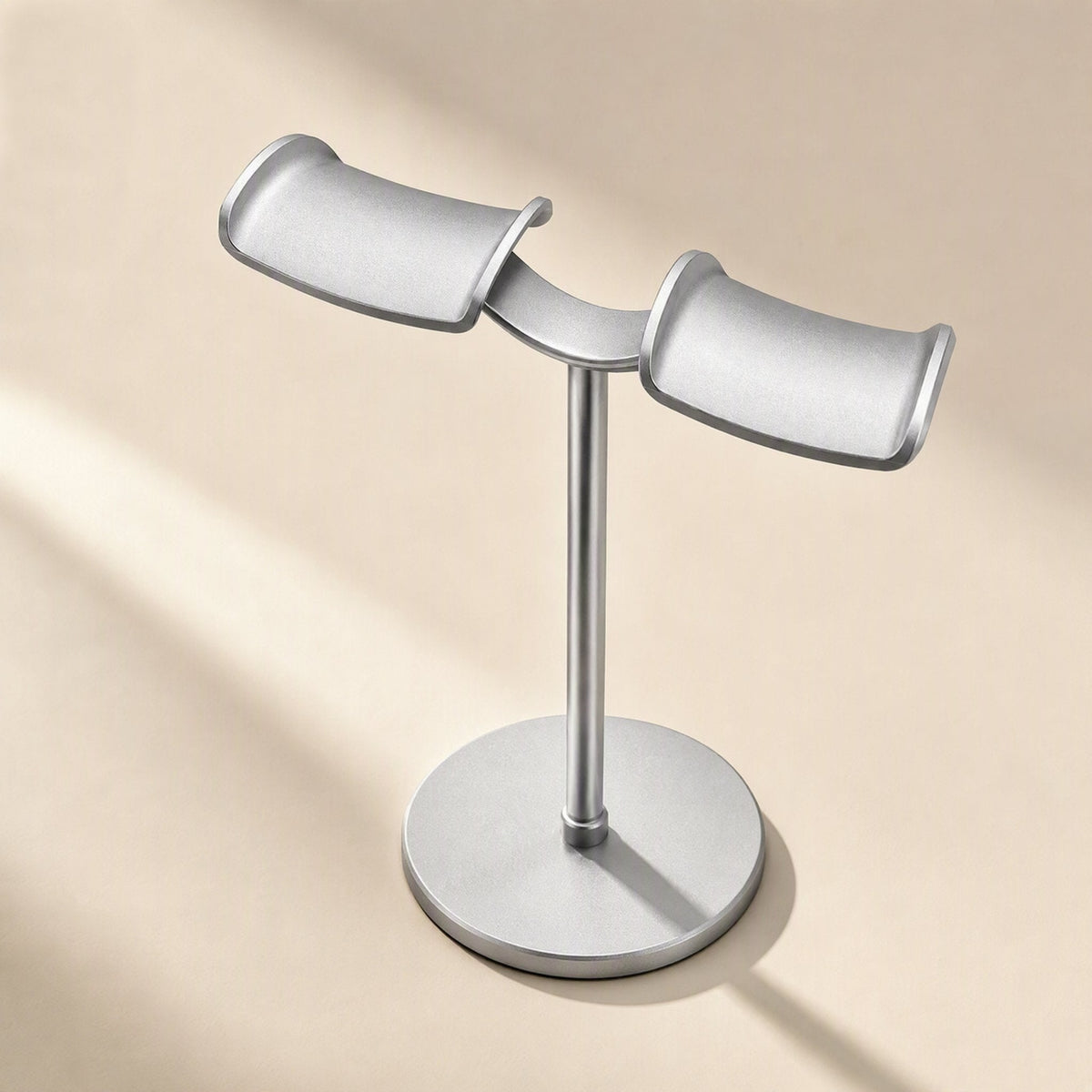 Twinrack Double Headphone Storage Rack – angled view of silver rack showing two curved cradle arms and a round weighted base