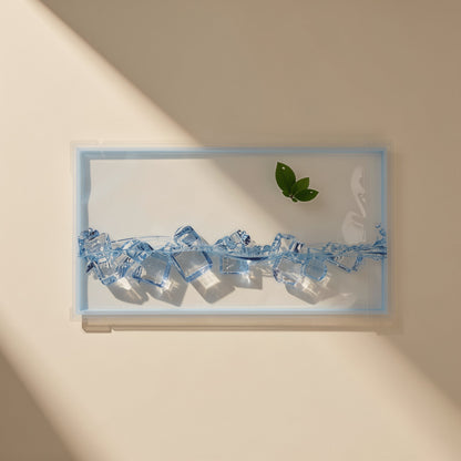 Chilldots – Single sachet with ice cubes along the bottom and a green leaf, lit by diagonal window light