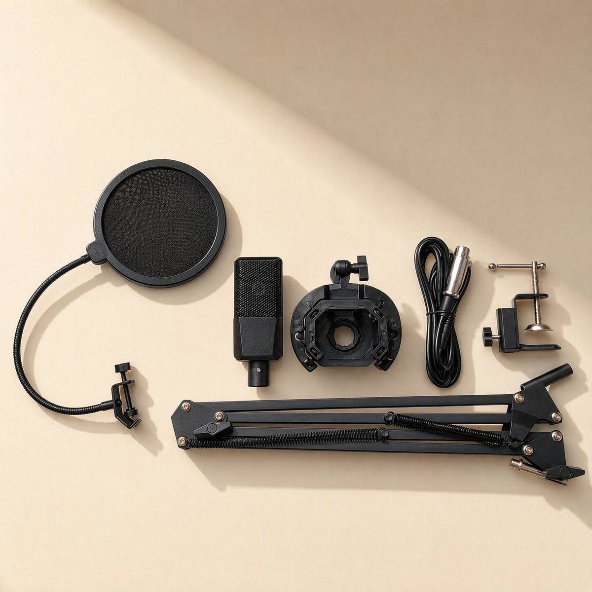 Tonecapture – Flat lay of pop filter, microphone, shock mount, XLR cable, desk clamp and folding boom arm