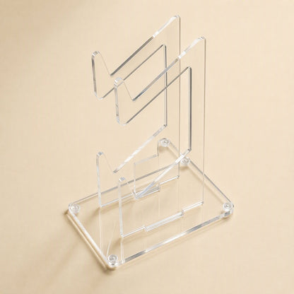 Padstand – Top-down angled view of the empty clear acrylic stand with two tiers and corner screws on the base