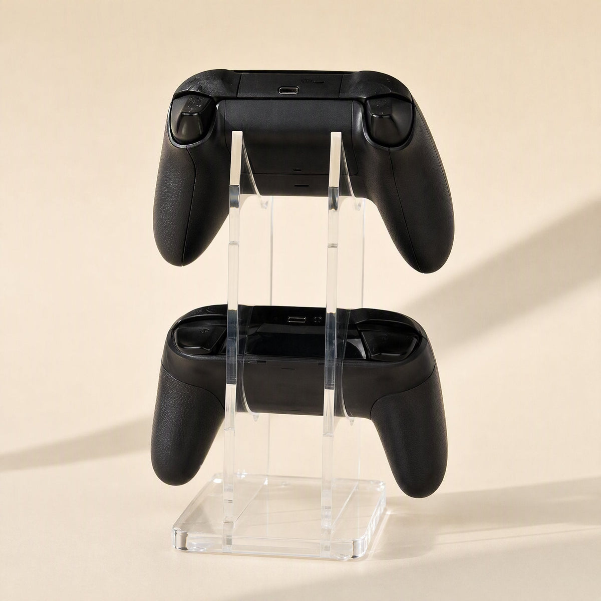 Padstand Acrylic Game Controller Stand – front view of the stand displaying two black controllers stacked one above the other