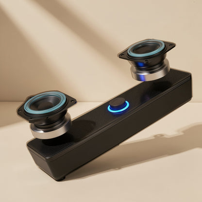 Deskbeat – Black speaker bar with two drivers lifted out of the top, showing blue-rimmed cones and a lit blue knob