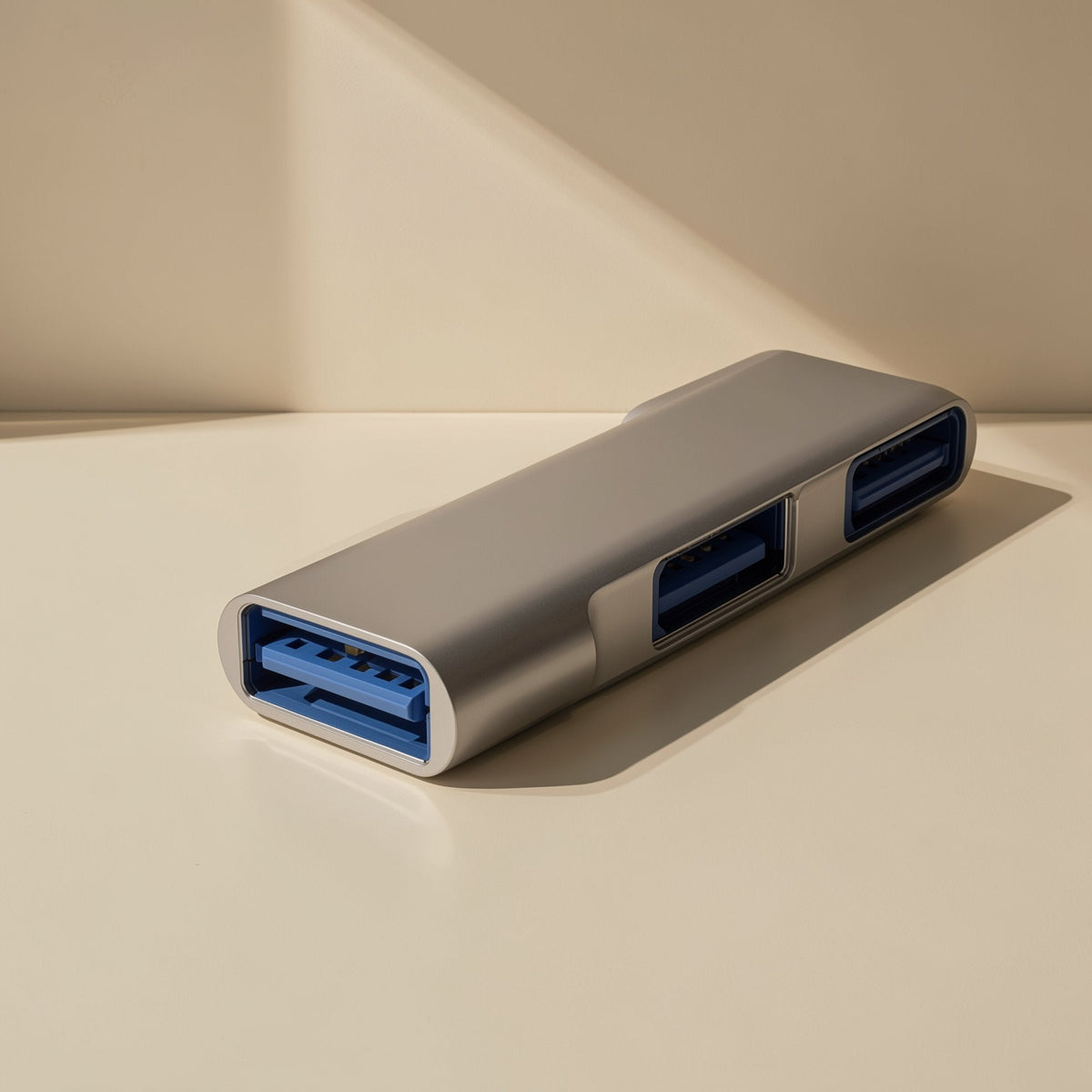 Docklink – Close-up of the hub's blue USB-A ports on a silver aluminum body resting on a cream surface