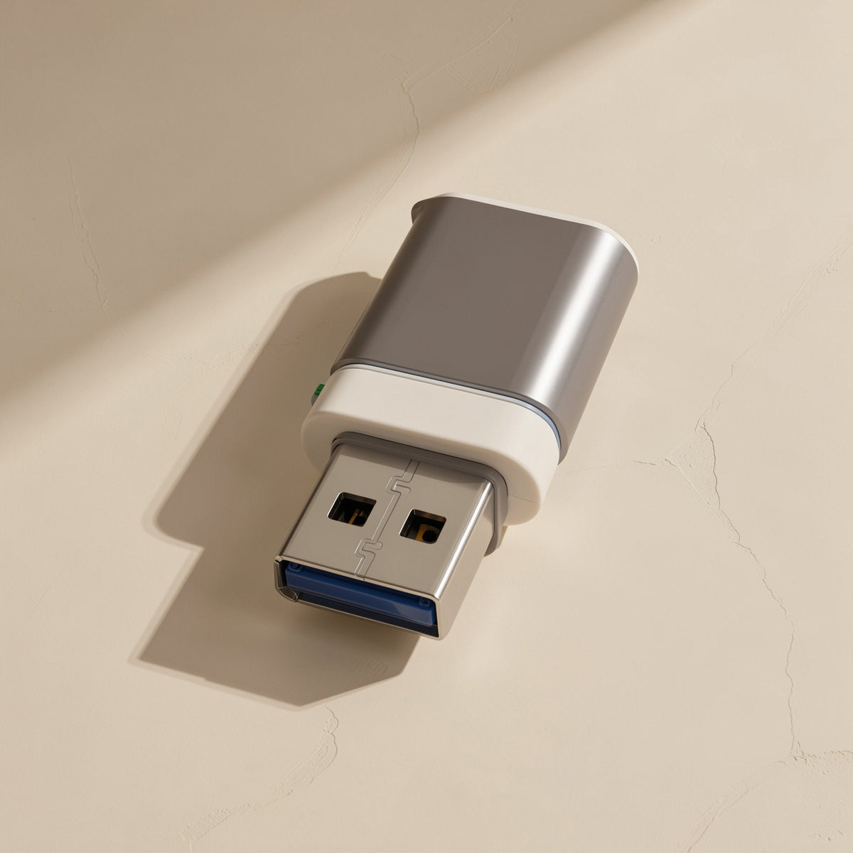 Docklink USB 3.0 OTG Docking Station – silver USB-A connector with white collar and cap lying on a textured beige surface