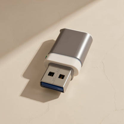 Docklink USB 3.0 OTG Docking Station – silver USB-A connector with white collar and cap lying on a textured beige surface