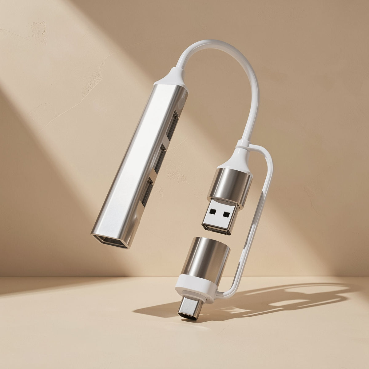 Docklink – Silver hub with the USB-C adapter detached from the USB-A plug, floating against a beige backdrop