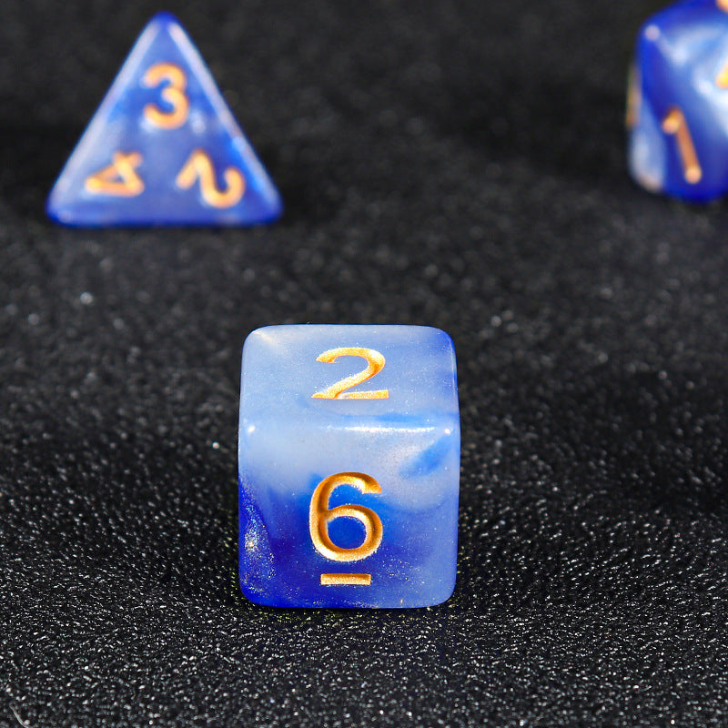 Facetforge – Close-up of a blue and white marbled d6 showing 2 and 6, with a d4 behind it on black fabric