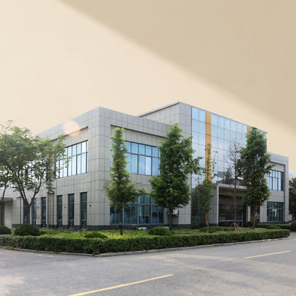 Chillchip – Modern grey office building with large glass windows, trees and hedges in front, seen from the car park