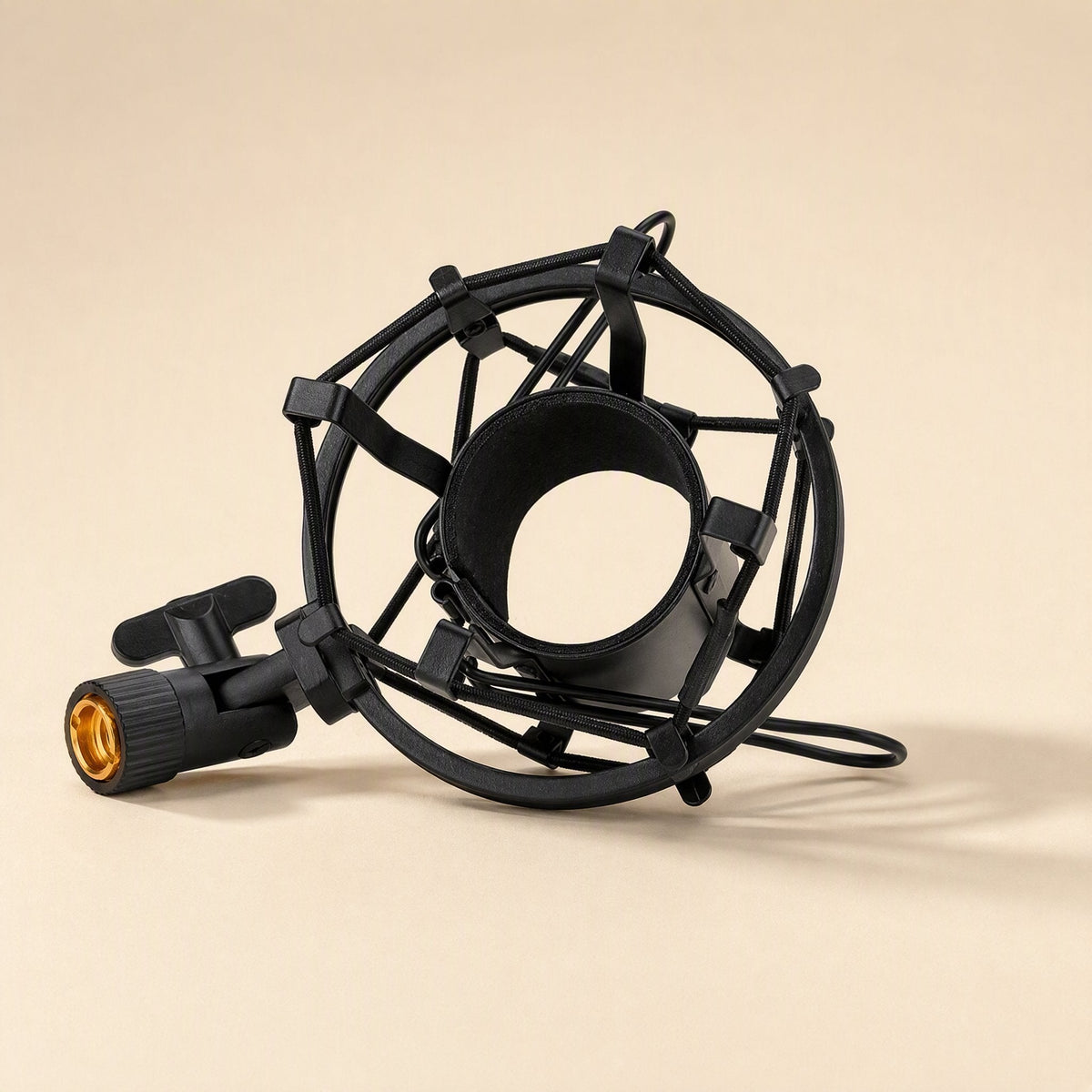 Calmstand – Black wire-suspended shock mount with a gold-threaded stand adapter, angled to show the open microphone cradle