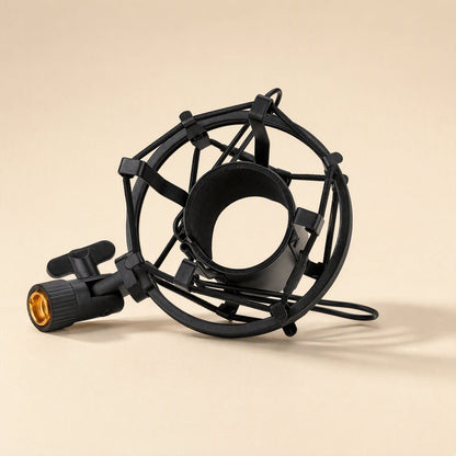 Calmstand – Black wire-suspended shock mount with a gold-threaded stand adapter, angled to show the open microphone cradle