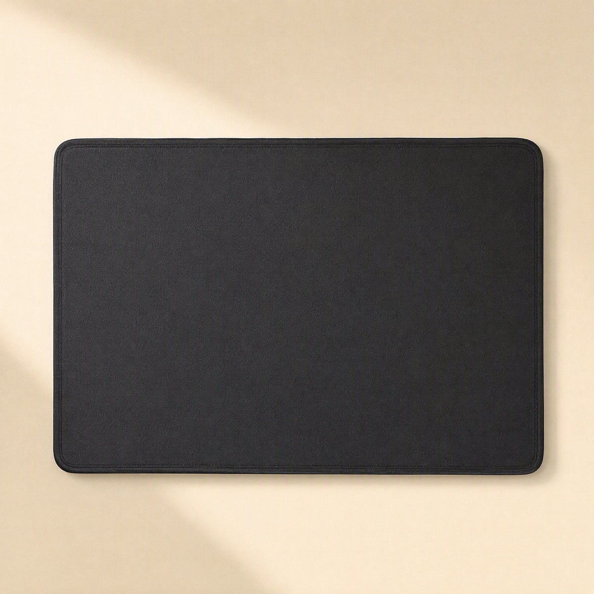 Coverloom Monitor Dust Cover – black dust cover laid flat, top-down view showing rounded corners and stitched edge
