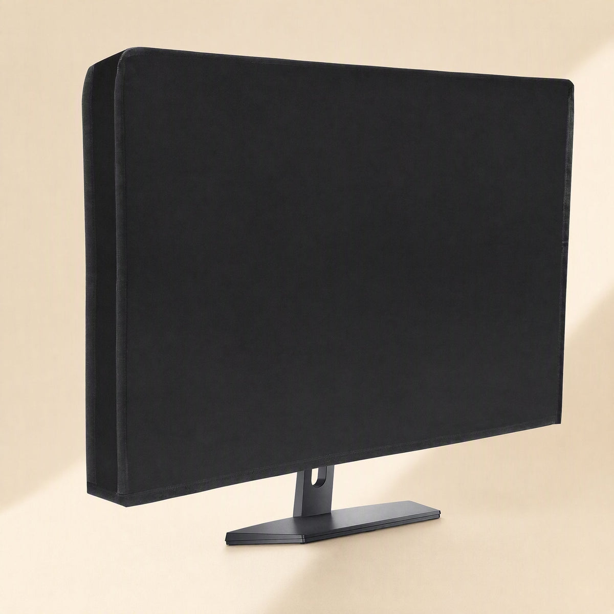 Coverloom Monitor Dust Cover – black dust cover fitted over a monitor on a stand, angled view from the left