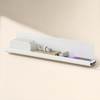 Wireledge PVC Under-Table Wire Management Rack mounted on a wall holding a speaker, cables and a phone