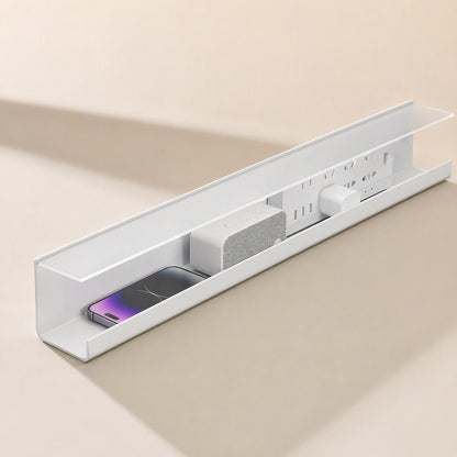 Wireledge – White cable tray seen from the end, holding a phone, speaker, power strip and charger inside