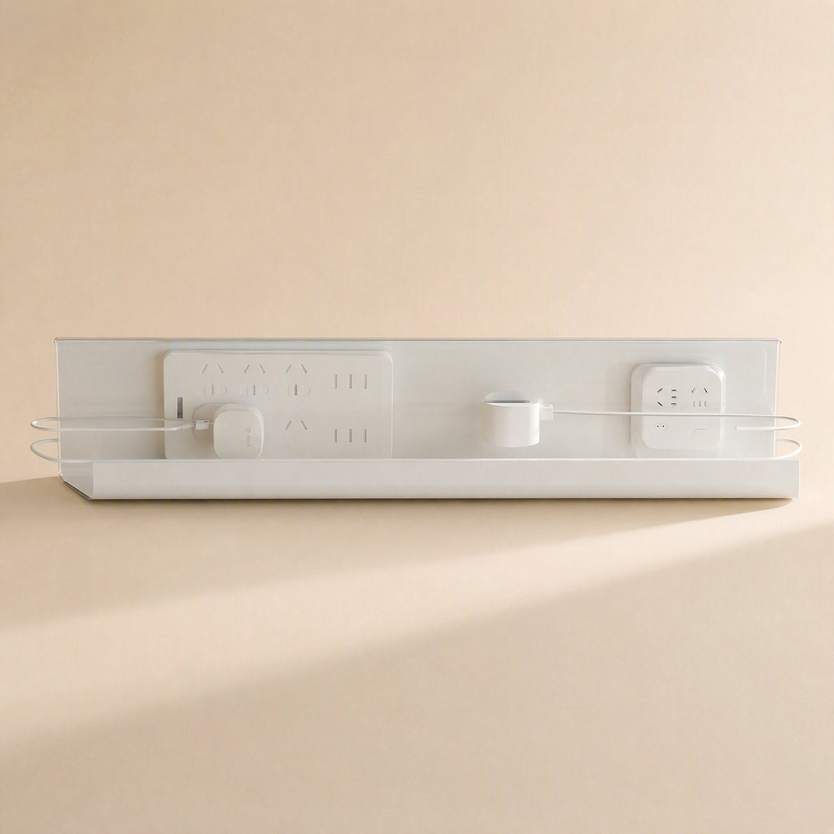 Wireledge – Front view of the white rack with a power strip and adapters mounted, cords looped through side wires